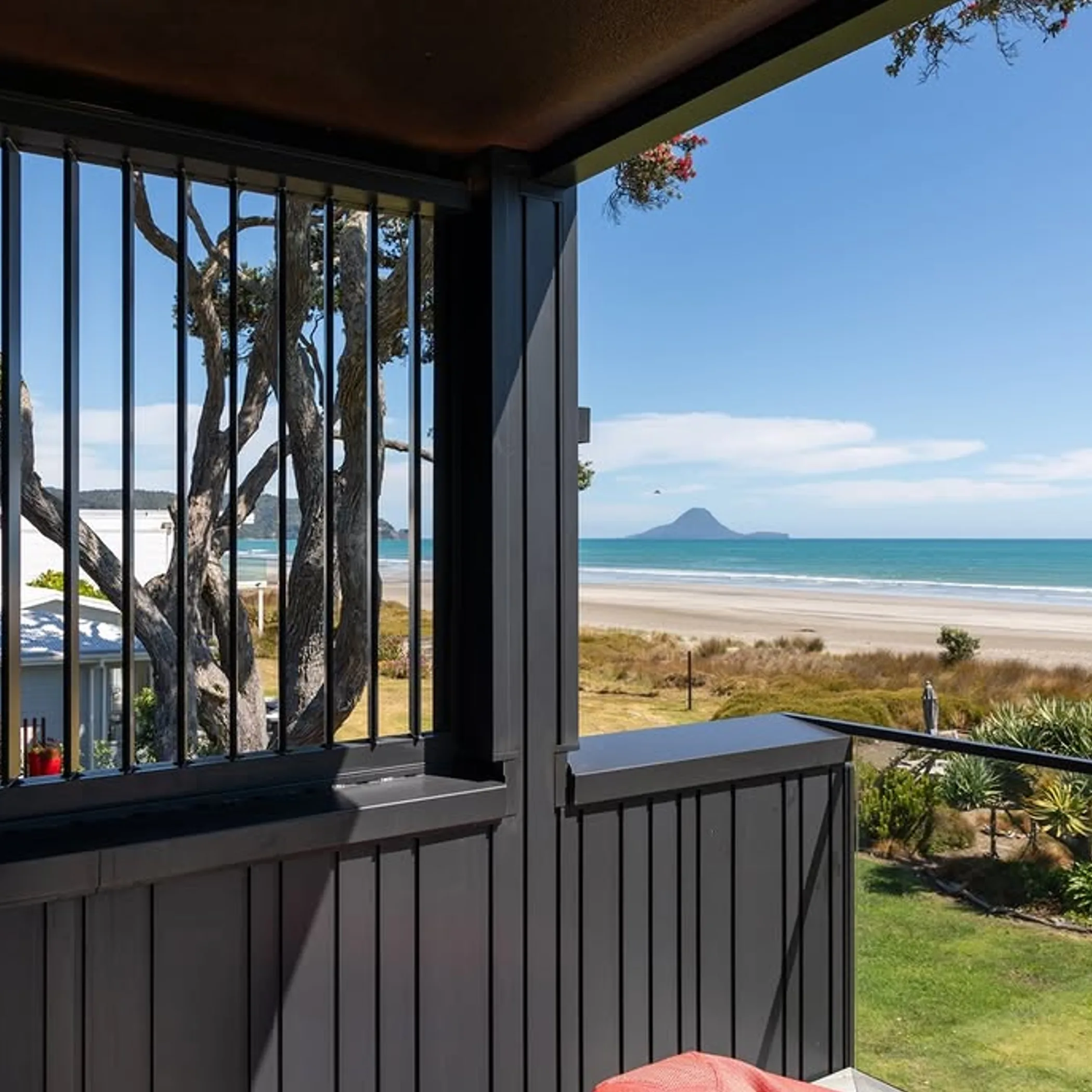 beachfront property with metal balcony